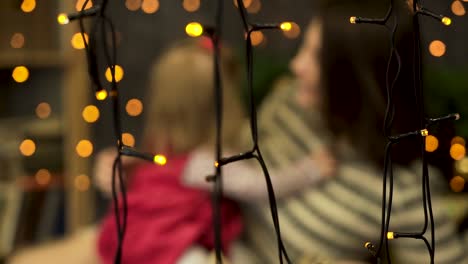 mom and daughter enjoying christmas lights