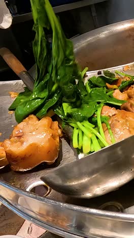 chef prepares traditional thai stewed pork leg