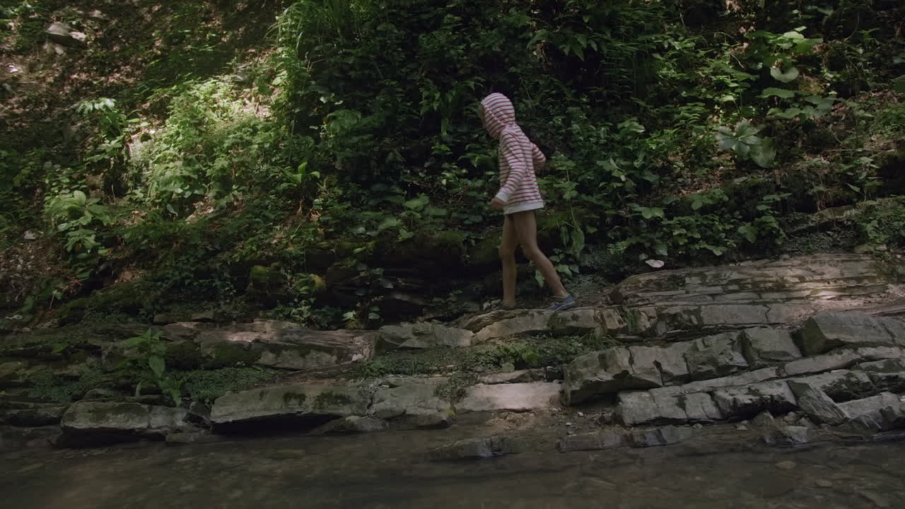 Child Hiking in a Forest Stream
