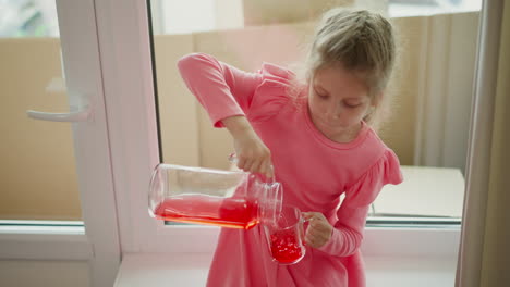 a girl pouring juice