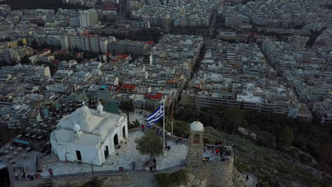 aerial drone shot coming over top of mount lycabettus in athens greece, 4k