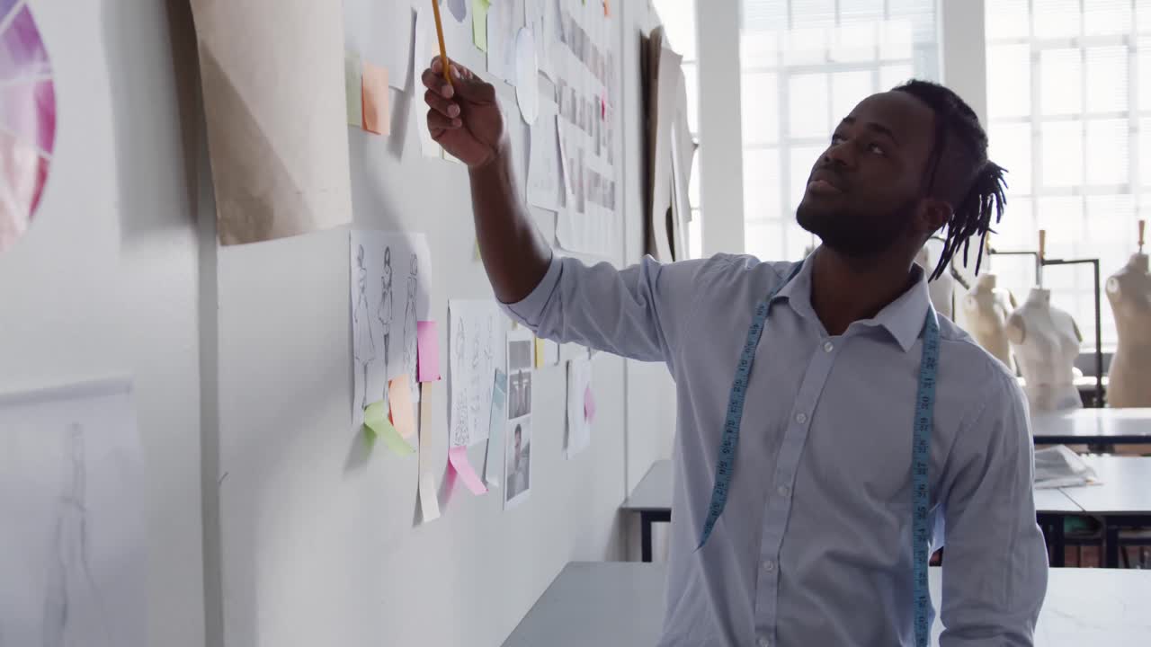 Mixed race man working in fashion office