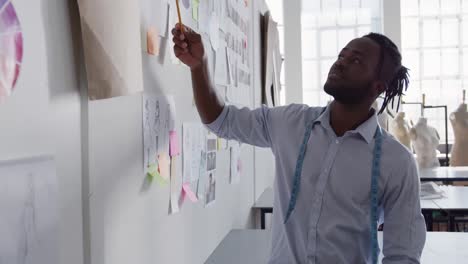 mixed race man working in fashion office