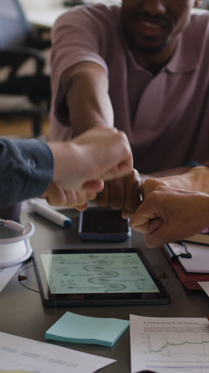 Business Team Fists Bumping in a Collaborative Meeting