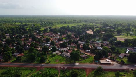 aerial establishing panorama of rural african village with virgin forest