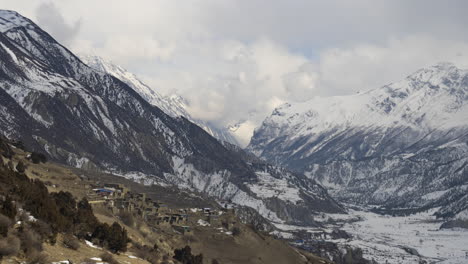 a remote mountain village nestled in a snowy valley
