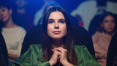 portrait of emotional woman watching sentimental movie in cinema