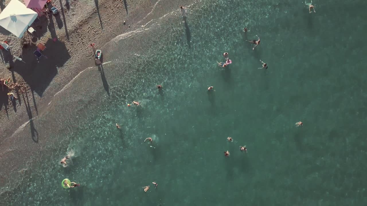 사람들이 수영 을 하고  을 고 있는 해변 의 공중 풍경
