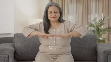 happy indian old woman doing breathe in breathe out exercise