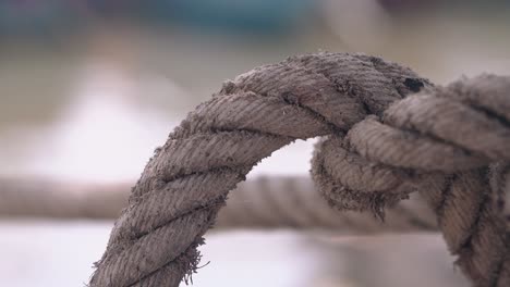 knot-on-ship-rope-connected-with-fishing-boat-over-water