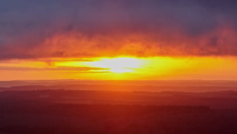 aerial shot captures the sun's golden embrace over vast fields