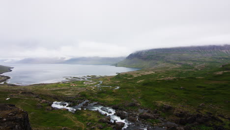 Majestic-natural-fjord-with-mountain-waterfall-runoff-river-in-Iceland