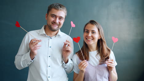 happy couple holding heart props