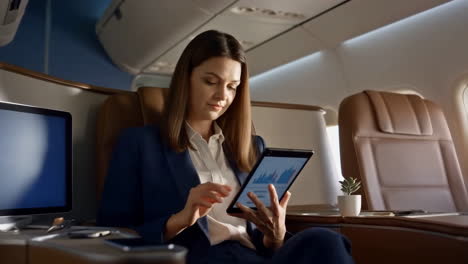 businesswoman working on tablet in private jet
