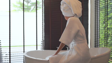 Asian-woman-preparing-to-take-a-bath-with-foam,-bubbles