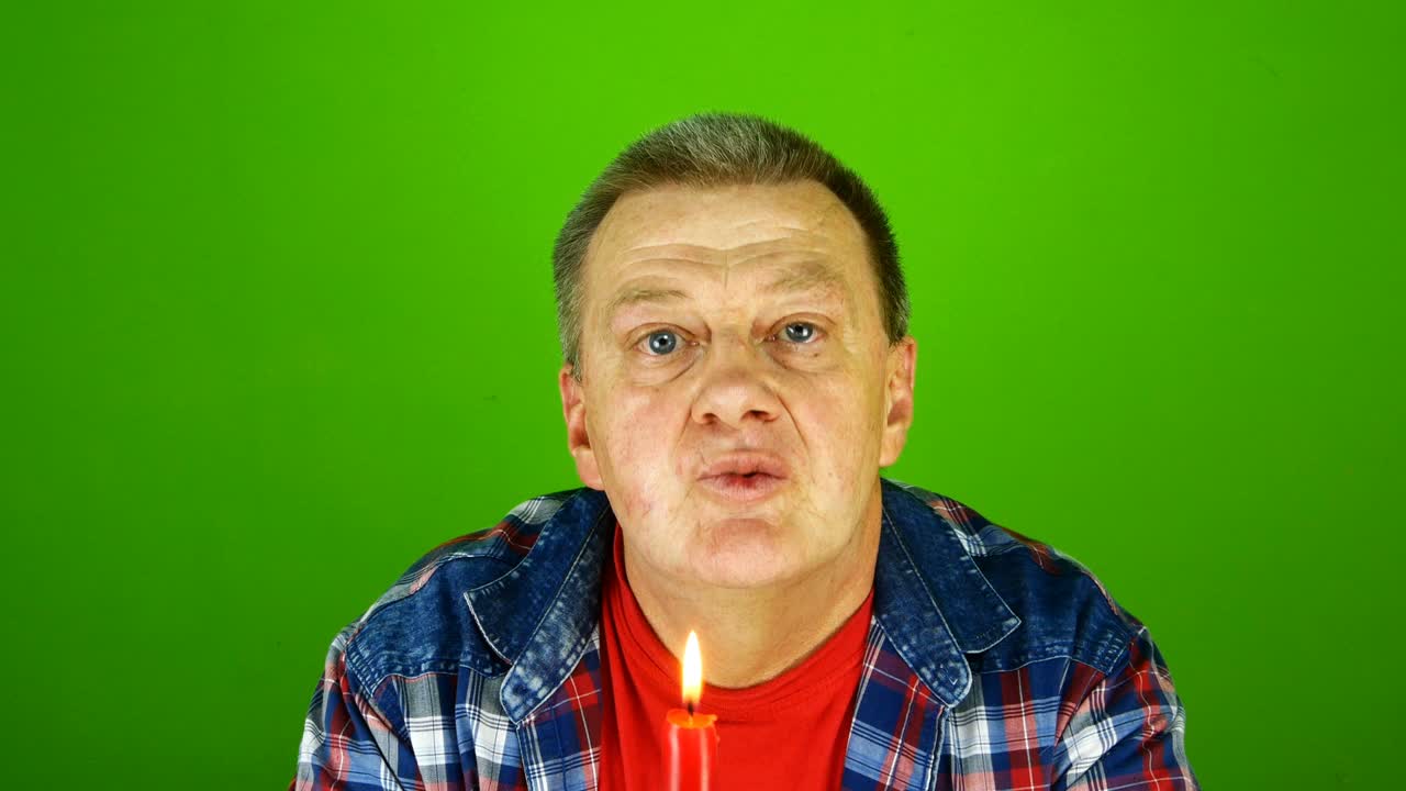Only mature adult caucasian ethnicity man preaches prays or speaks memorial speech with burning candle in his hands.