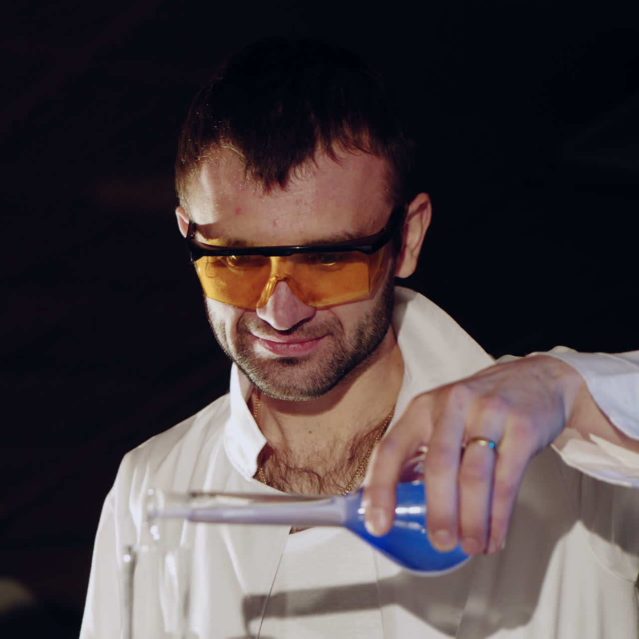 Woman scientist mixing together two liquid substances. Experiments in a chemistry lab. Close-up Square video