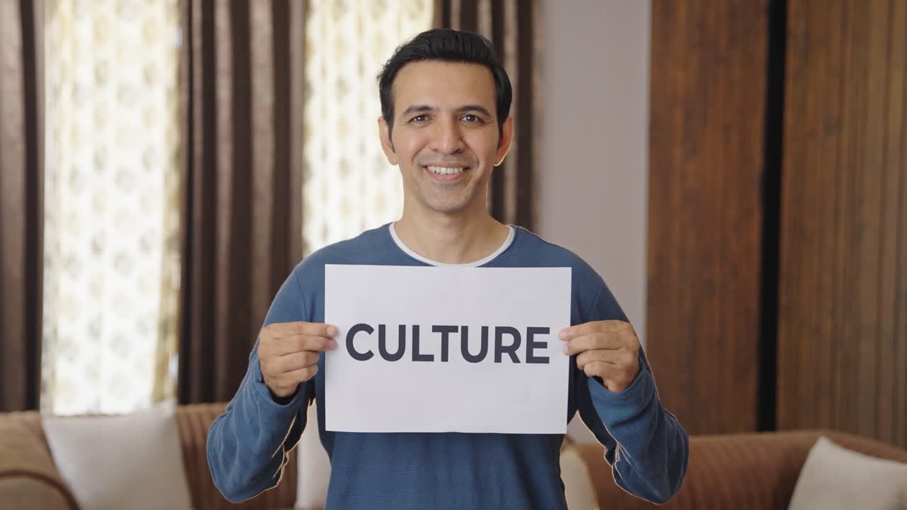 Happy Indian man holding CULTURE banner