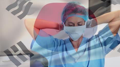 animation of flag of south korea waving over female surgeon in operating theatre
