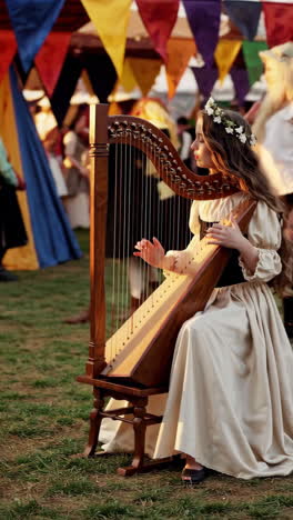 young girl playing harp at a renaissance fair