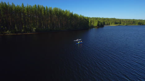 two people out kayaking on a river in the sun