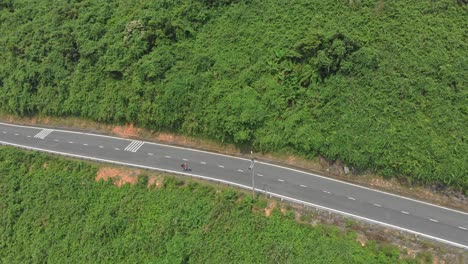 motorbikes are driving at famous hai van pass road at vietnam, aerial