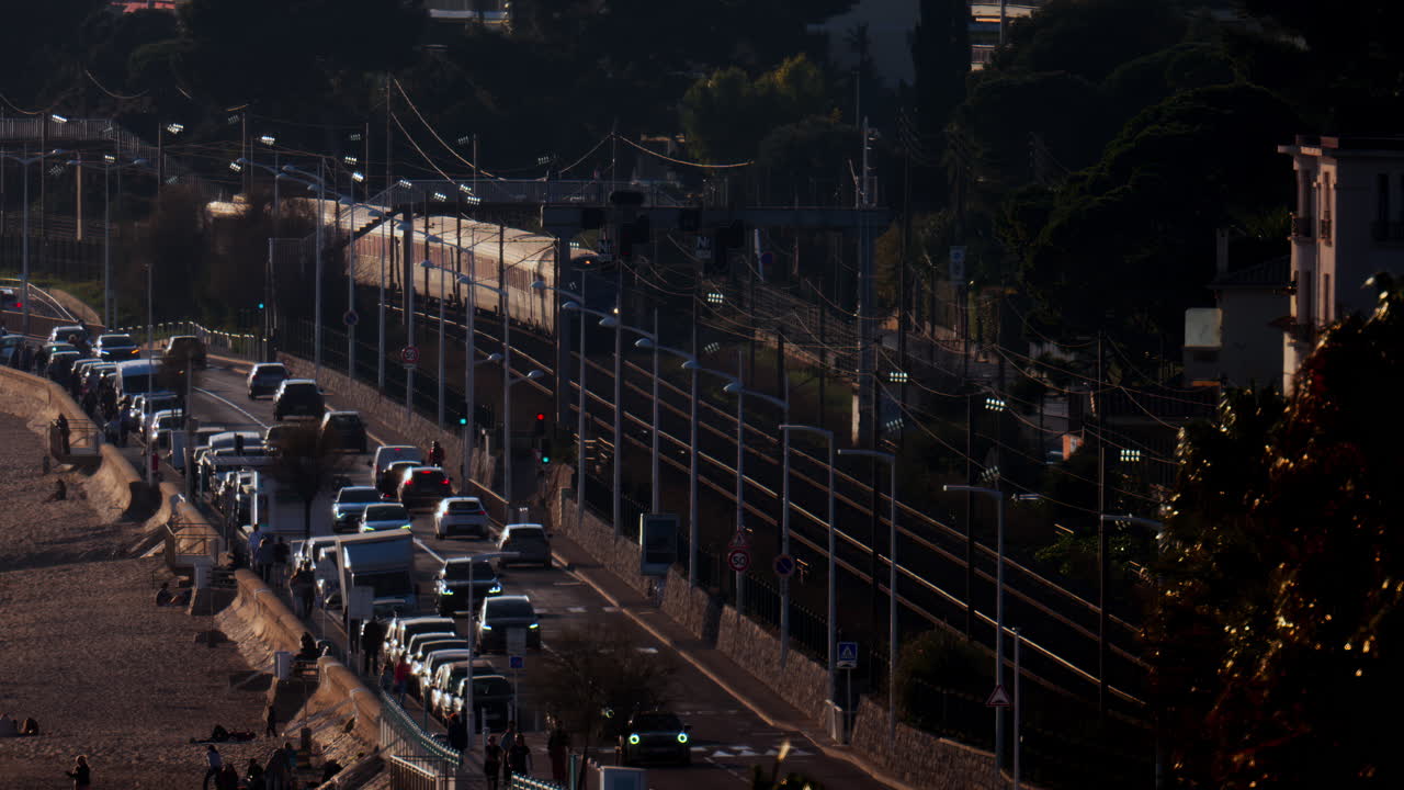 Cannes, France - March 13, 2025: Distant view of a train moving on the rails near the beach