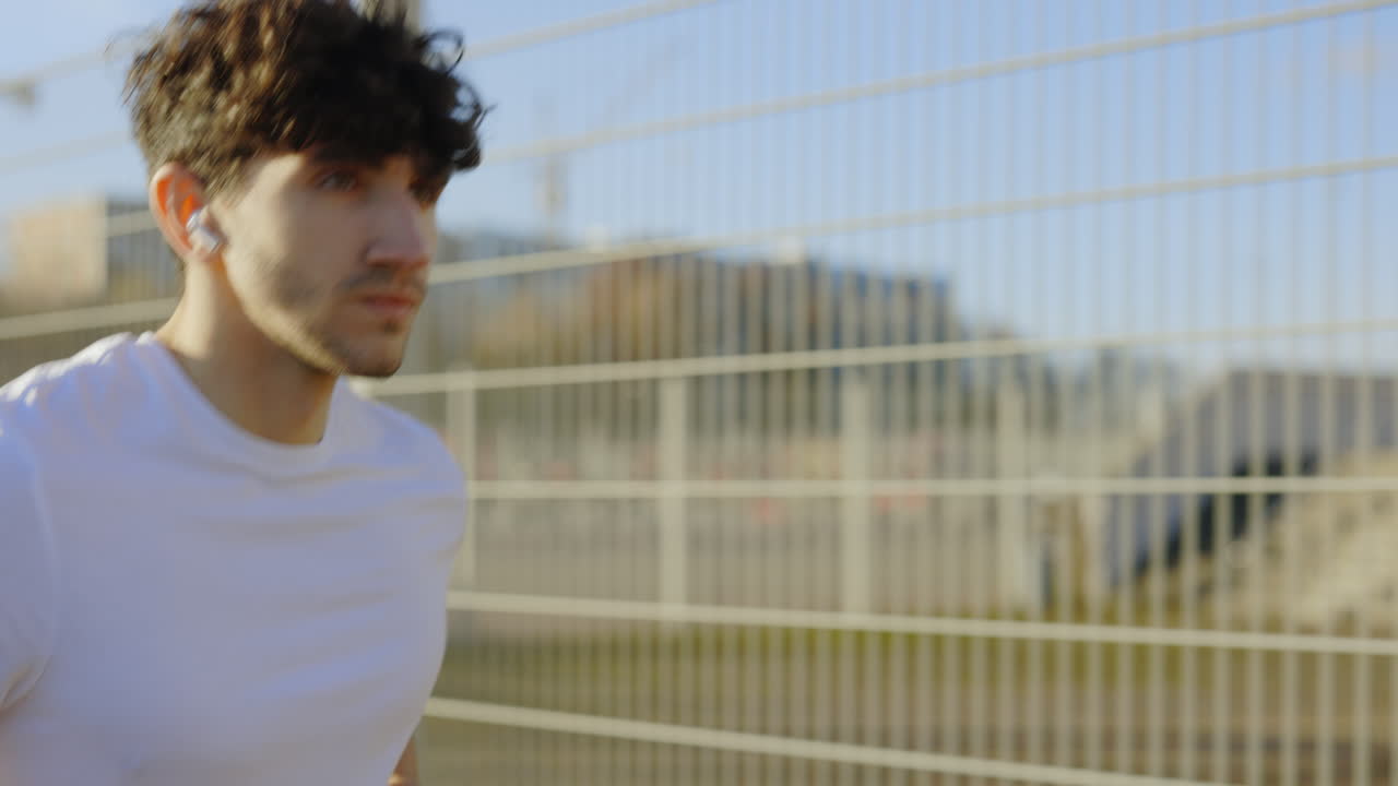 Man Running Outdoors with Earbuds