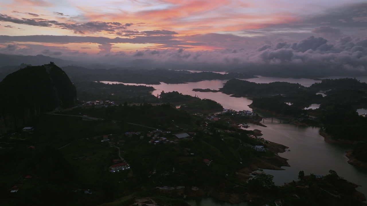 Left Aerial Pan Guatapé El Penon Rock Colombia Sunset Clouds Lake Darkness