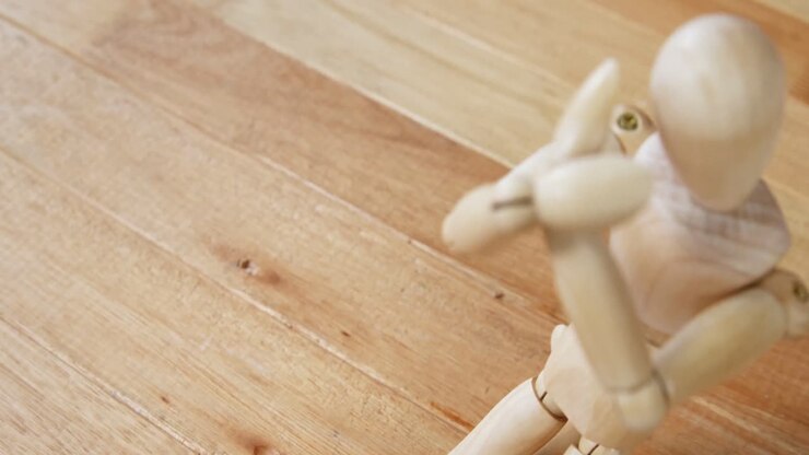 Figurine kneeling in front of broken heart