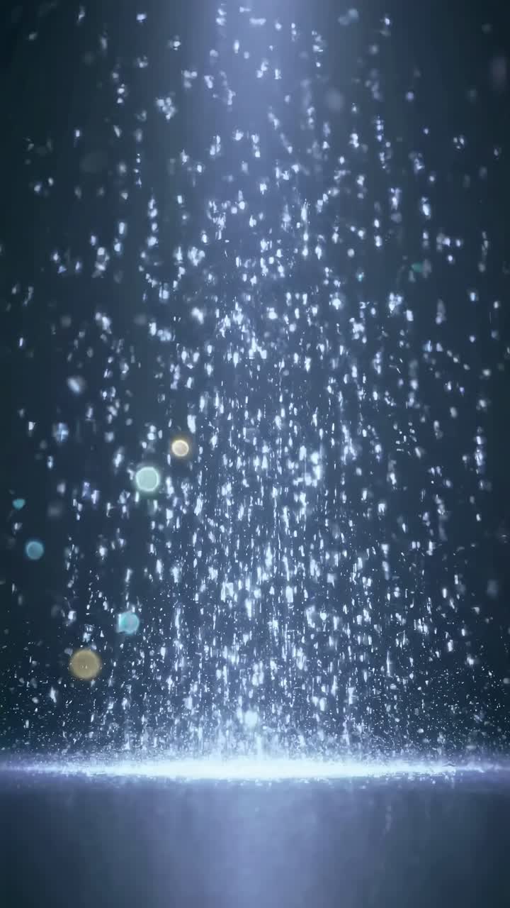 A mesmerizing video of falling particles captured from a low angle, creating a serene, ethereal