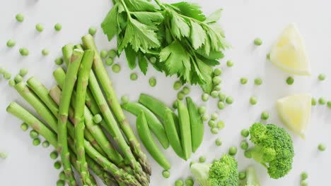 video of close up of fresh green vegetables on white background