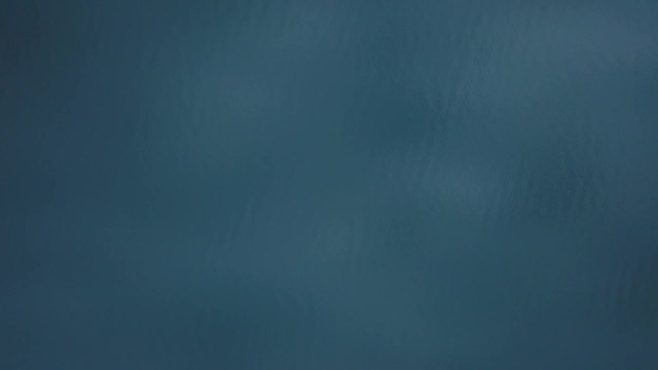 Drone flying over calm water