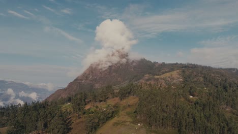 clouds covered the mountain peak in daytime in peru. - aerial shot