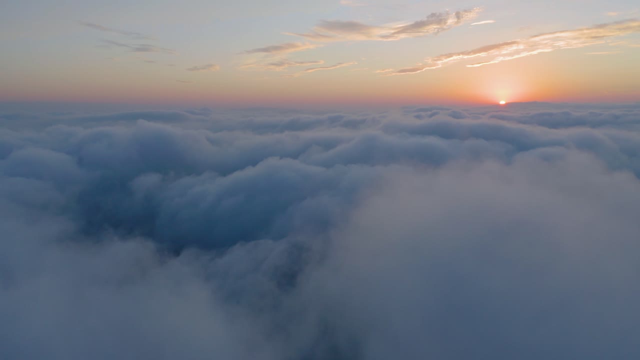 Aerial view above the clouds at the sunset