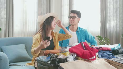 Asian Couple Travelers Packing Clothes In A Suitcase And Selfie For A New Journey. Luggage For Travel Holidays And Vacation