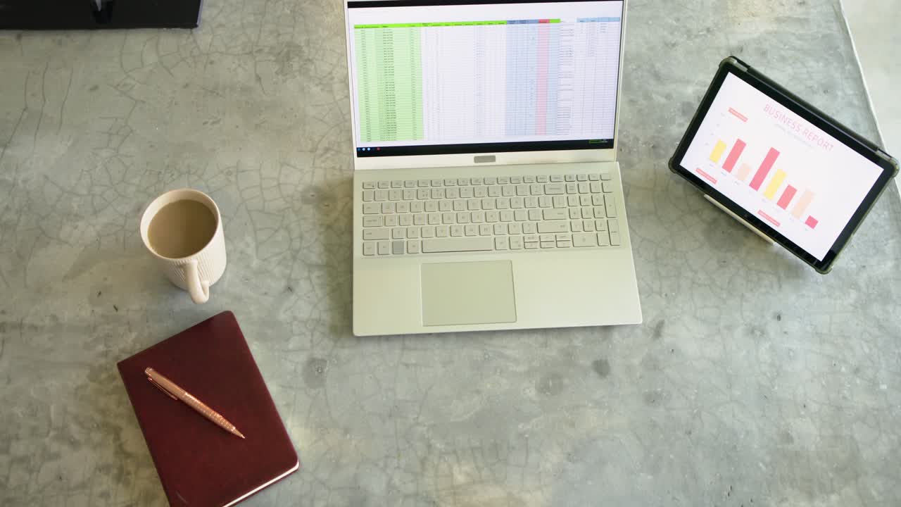 Camera starting overhead view panning left-to-right revealing home office workspace on stone table