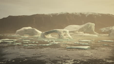 gigantic ice block structures on the black sand by the sea shore