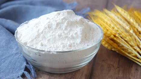 flour in glass bowl with wheat ears