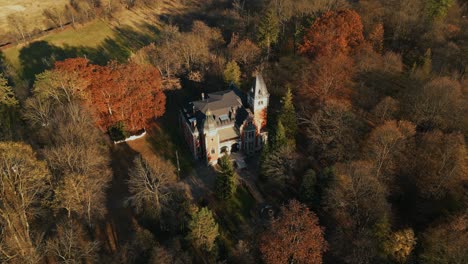 Aerial View Of Ghica Castle Surrounded By Autumn Colors In Dofteana, Romania. orbiting shot