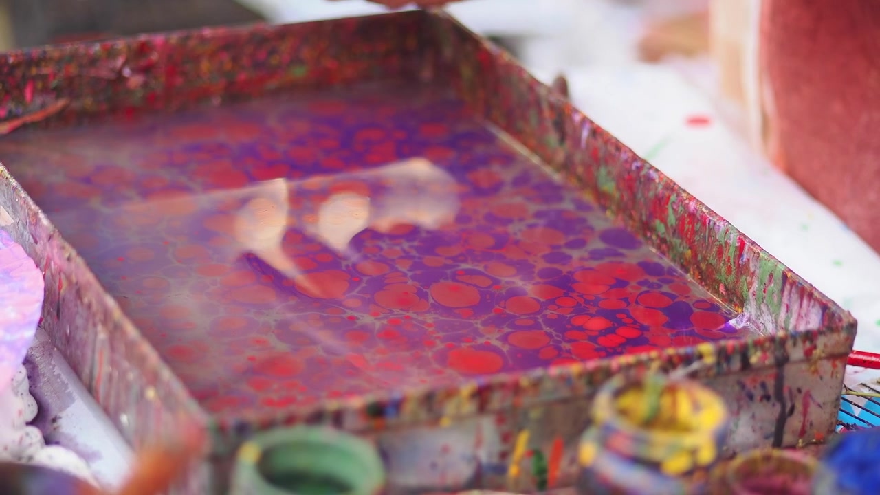 Artist Creating Ebru Marbling Art on Water Surface