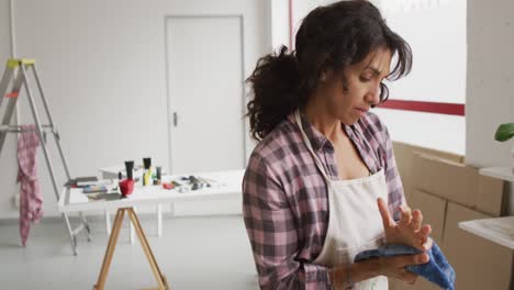 video of thoughtful biracial female artist in studio