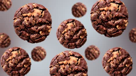 una corriente de deliciosas galletas de chocolate de diferentes diámetros diámetros en un fondo de color blanco. imágenes 4k uhd. diseño futurista, diseño de movimiento animación. diseño de arte pop, creatividad dulces de navidad concepto de comida