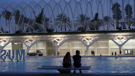 couple at the city of arts and sciences, paddle boarding in valencia, spain, summer evening