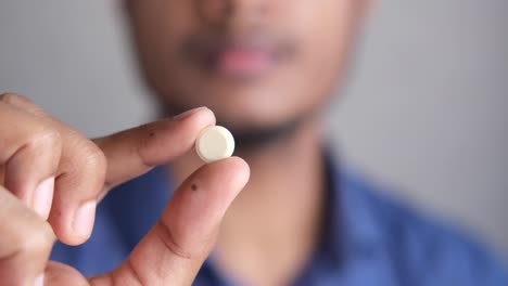 person holding a pill