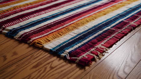 colorful striped rug on wooden floor