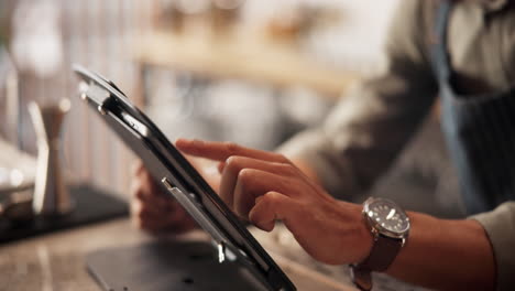 cafe worker using tablet for order