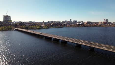 harvard bridge over the charles river joining boston to cambridge - aerial tracking view