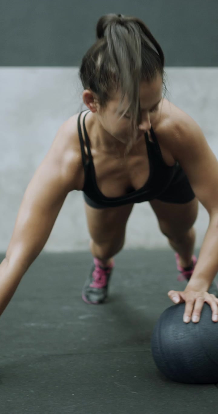 Athletes Performing Push-Up Variations in a Gym