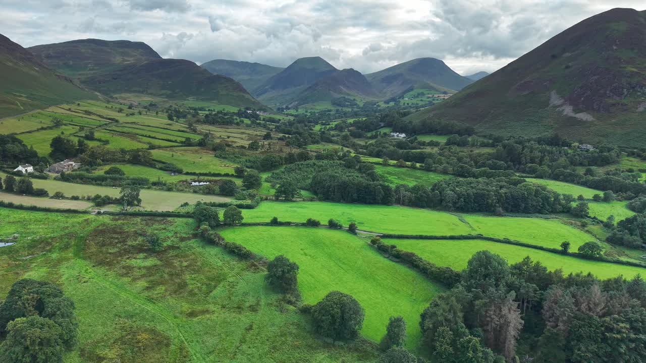 Gloomy, cloudy evening over the lush green fields and hills of the Newlands Valley